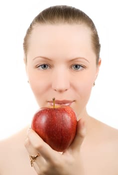 Portrait of young woman with apple isolated on white