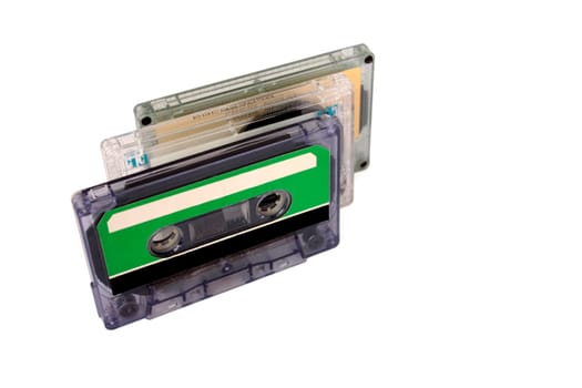 Three Compact Cassette isolated on white. Vertical perspective view