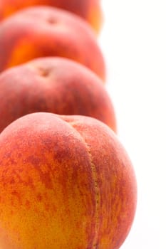 four peaches closeup on white background