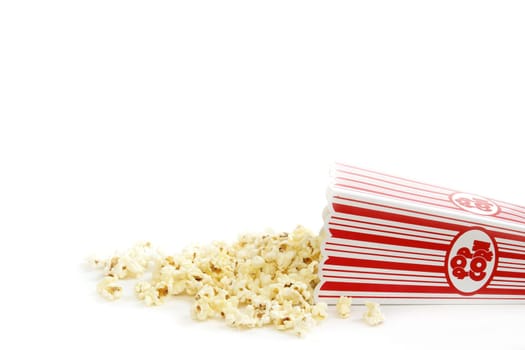 A bucket of popcorn has spilled out.