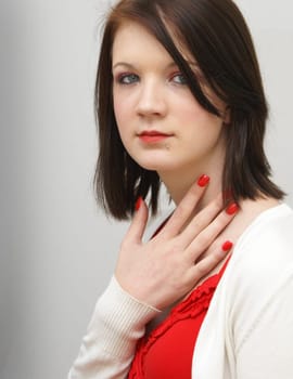 A young woman standing and communicating with body language.