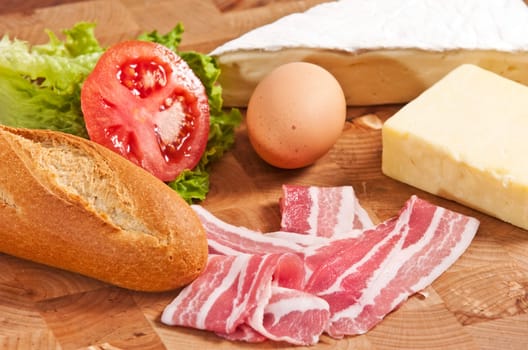 bacon and egg sandwich on wooden board