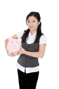 Beautiful Asian businesswoman holding a piggy bank