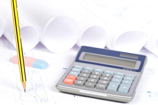 Construction plans, calculator and drawing tools. Shallow depth of field