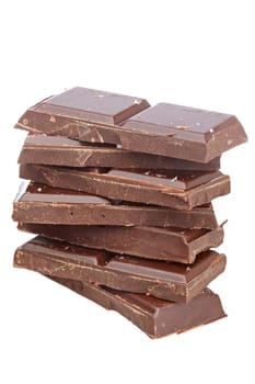 Blocks of chocolate isolated on white background. Shallow depth of field