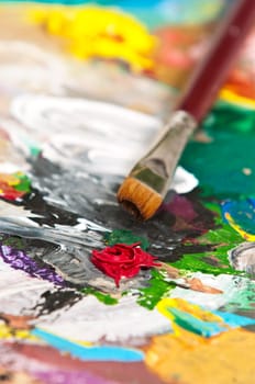Detail of a paintbrush on an artist's palette