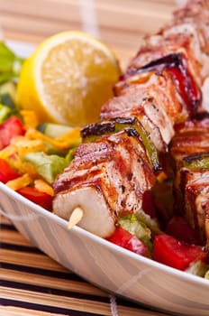 Grilled chicken kebab served with a fresh salad