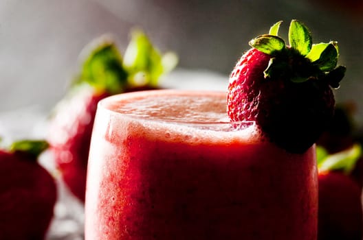backlit glass of freshly made strawberry smoothie
