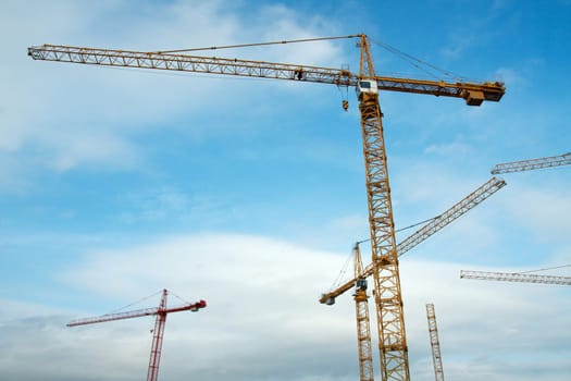 Tower cranes against blue sky