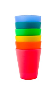 A rainbow-like stack of colorful plastic cups in pink, red, yellow, green, turquoise and blue.