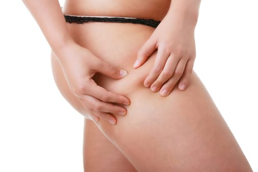 Woman pinching leg for skin fold test isolated on white background
