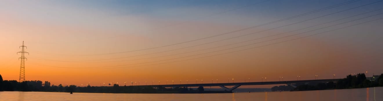 Panorama of the bridge against the sunset sky