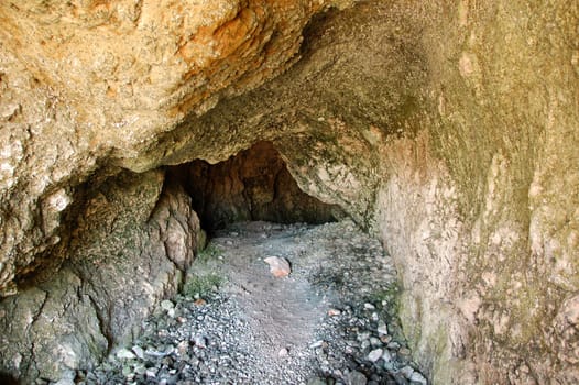 Narrow natural cave interior.