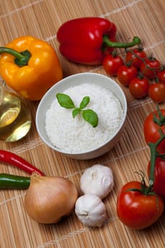 A bowl of perfectly cooked, plain Basmati rice, in an Asian style bowl, with a garnish of Thai Basil