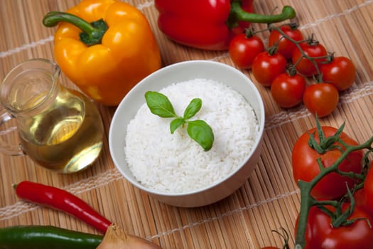 A bowl of perfectly cooked, plain Basmati rice, in an Asian style bowl, with a garnish of Thai Basil
