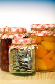Put aside when you have plenty - money saving concept with coins in a jar