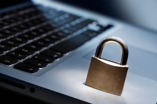 Lock on laptop keyboard with shallow depth of field
