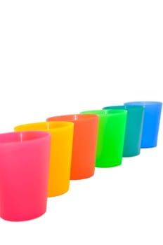 A rainbow-like array of colorful plastic cups in pink, yellow, red, green, turquoise and blue.