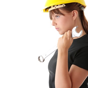 Young woman builder at work with big french key, isolated on white