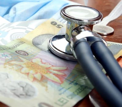 Recession concept: money and a stethoscope. Close up shoot.