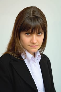 Portrait of the beautiful business girl in a black suit