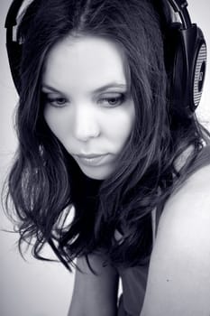 Monochrome portrait of charming young girl in earphones