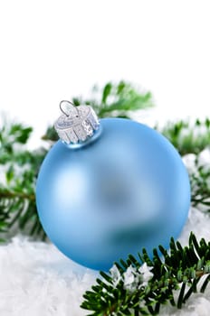 Blue Christmas decoration in snow with pine branches
