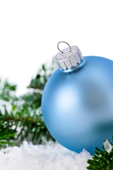 Blue Christmas decoration in snow with pine branches