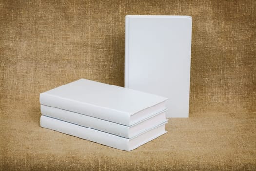 Still-life from several books with white cover on canvas background
