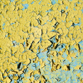Old grunge yellow wall with cracks and stains