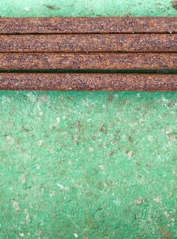 Old concrete painted wall with rusty iron pipes
