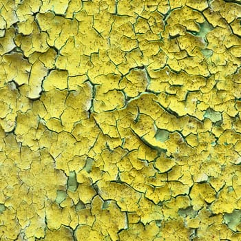 Old yellow wall with cracks and stains