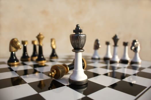 The end of a duel on a chessboard, the light wins the dark king is fallen