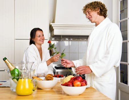 Young couple enjoying a luxurious champagne breakfast on a sunday morning