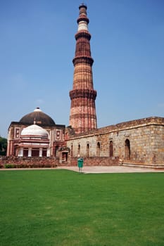 Qutb Minar. Ancient islamic victory tower in landscaped gardens. Delhi, India