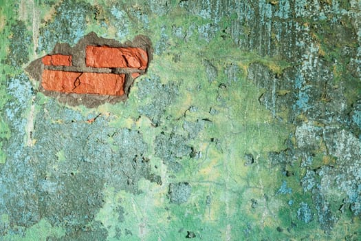Damaged painted old brick wall with hole