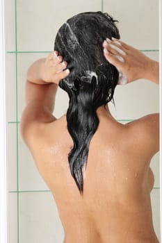 Young woman in shower washing her hairs