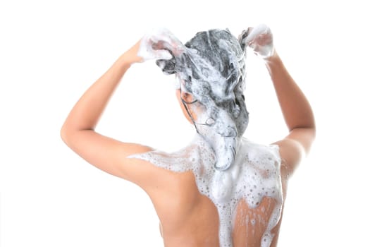 Young woman in shower washing her hairs isolated on white background