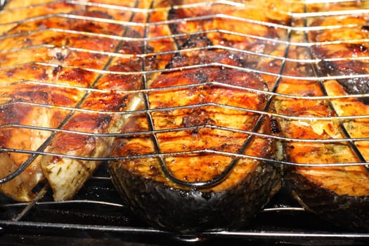 Salmon cooking on grill. Shallow DOF