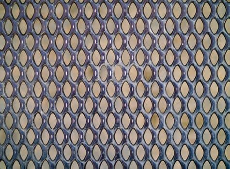 Metal grate at a playground with background