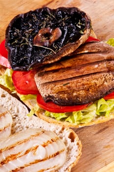 Portobello sandwich with grilled onion lettuce and tomato