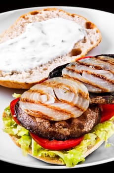 Portobello sandwich with grilled onion lettuce and tomato