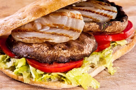 Portobello sandwich with grilled onion lettuce and tomato