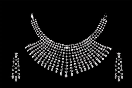 Diamond necklace on dark black background with ear rings