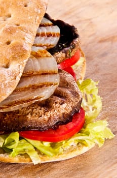 Portobello sandwich with grilled onion lettuce and tomato