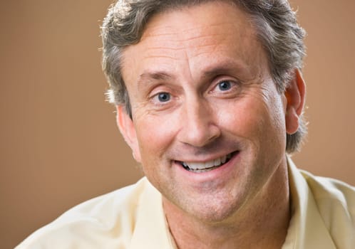 Attractive male smiling at camera. Headshot. Horizontal