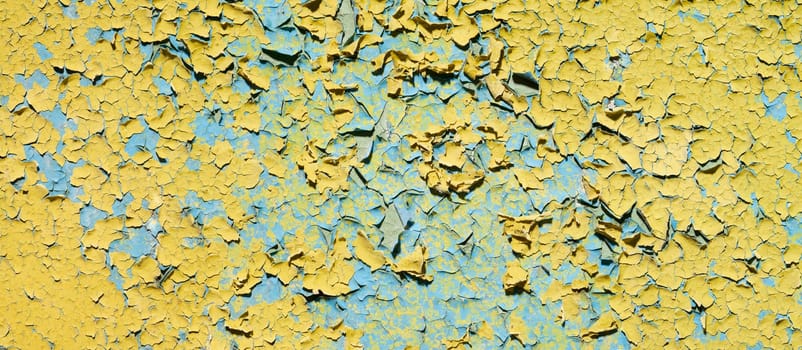 The old grunge cracked yellow wall of ruins