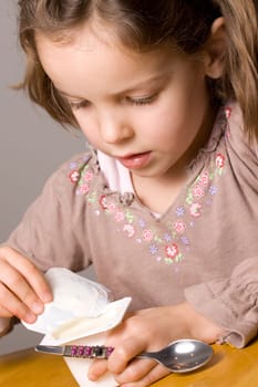 Little girl opening yogurt