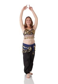 Young Caucasian belly dancing girl in beautiful decorated clothes on white background and reflective floor. Not isolated