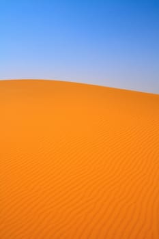 sand dunes and cloudless sky, Erg Chebbi, Morocco, focus set in foreground